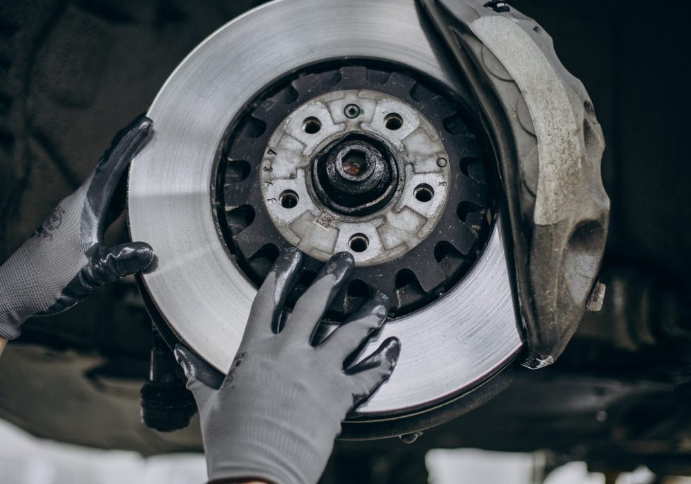 Mechanic changing brake discs in car service